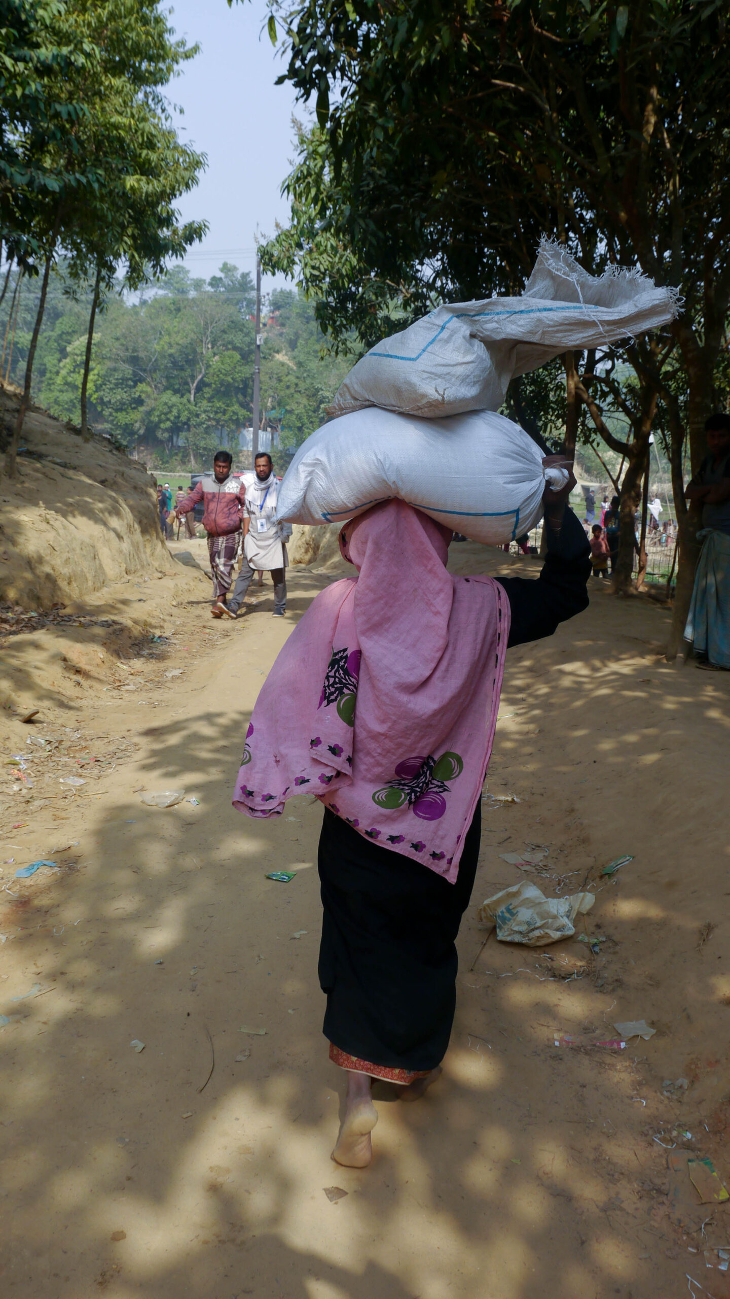 Rohingya women carrying rice